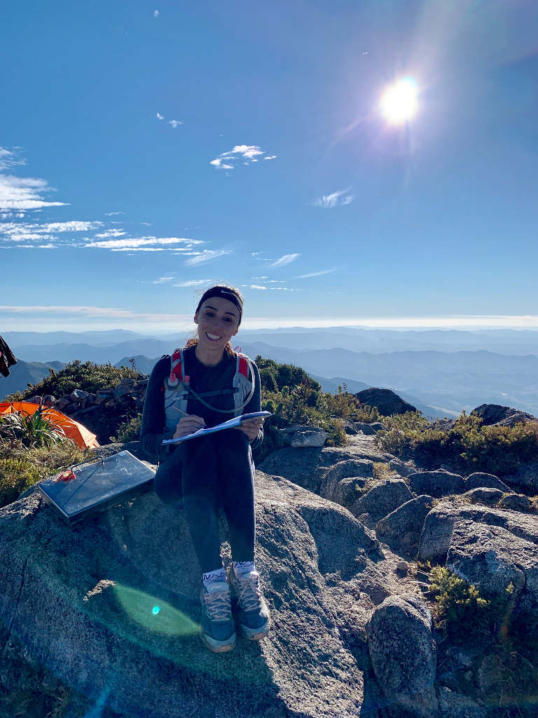 Carol signing the summit logbook at Pedra da Mina