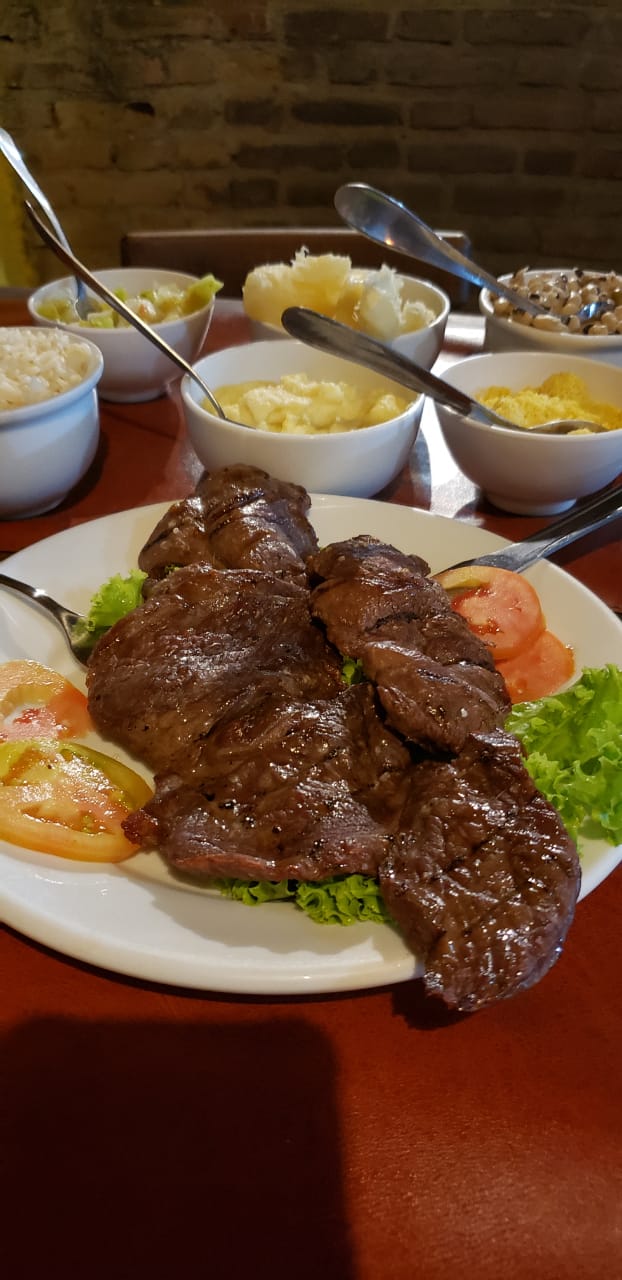Goat meat and side dishes at Olinda Art e Grill