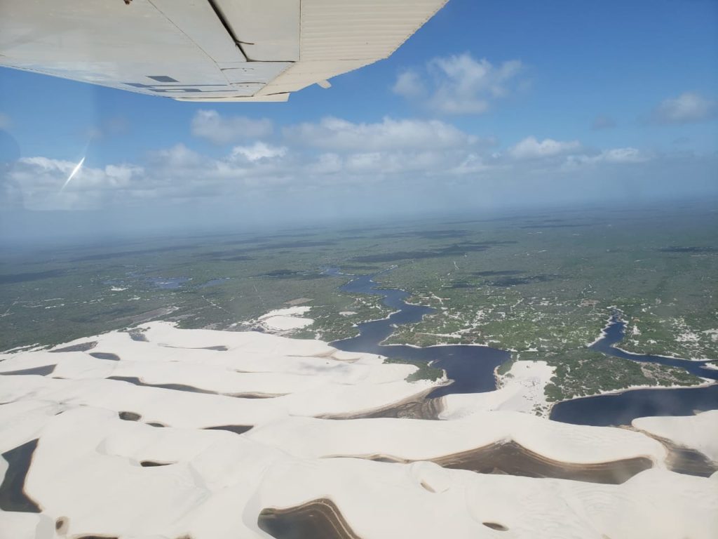 Aerial view flying over the dunes along the Rio Preguiça