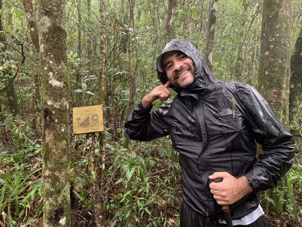 Andrey next to the sign marking where cell signal is available